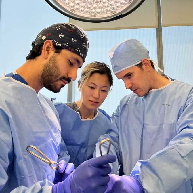 Doctors in scrubs operating