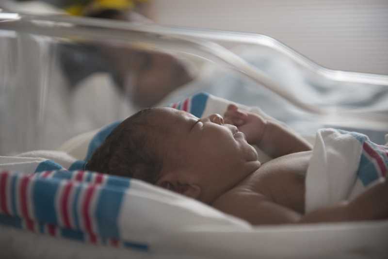 Newborn in hospital bassinet