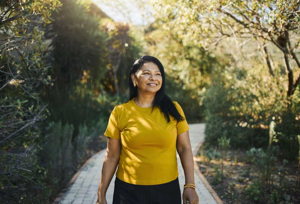 Woman in yellow shirt in park