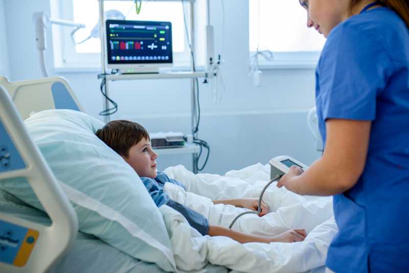 nurse at bedside with child