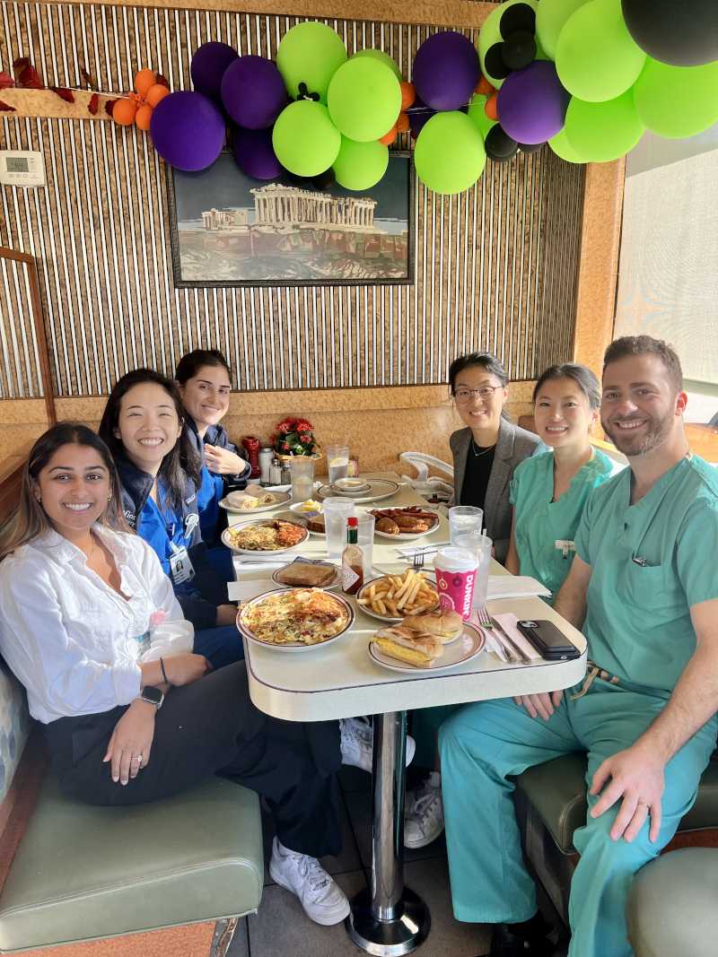 Group sitting at Diner booth under ballons