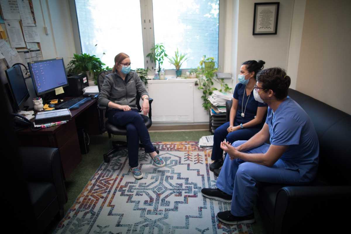 Hospital employees having a meeting in an office.